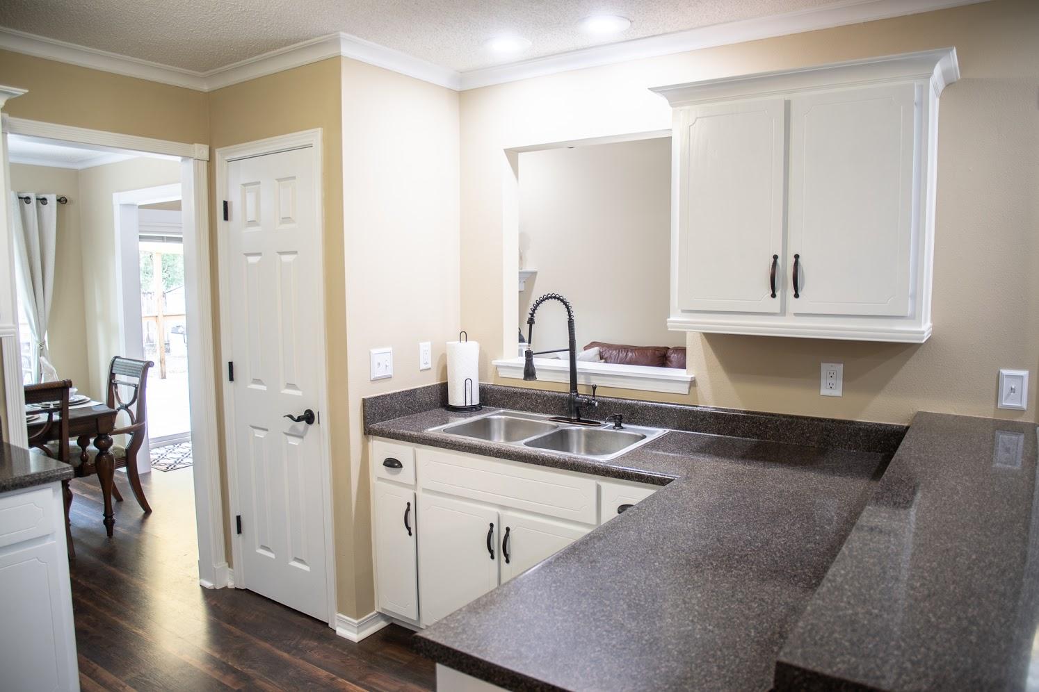 2802 Ping Lane Crestview, FL 32539 - Photo 11 of 30 a kitchen with stainless steel appliances granite countertop a sink stove and cabinets