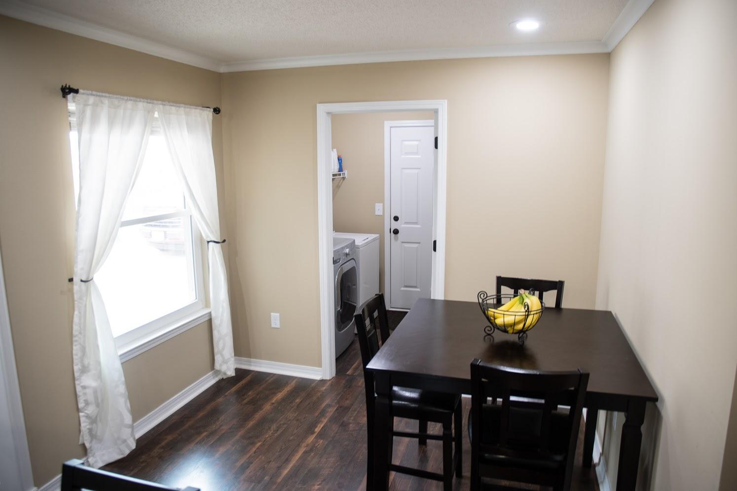 2802 Ping Lane Crestview, FL 32539 - Photo 12 of 30 a view of a dining room with furniture and wooden floor