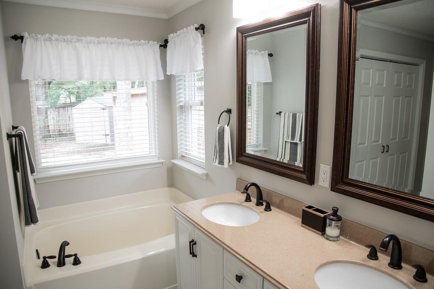 2802 Ping Lane Crestview, FL 32539 - Photo 16 of 30 a bathroom with a tub sink and mirror