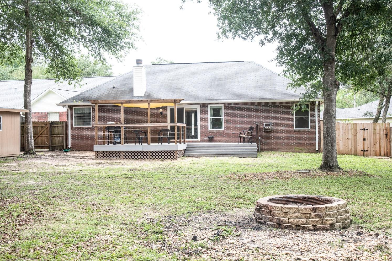 2802 Ping Lane Crestview, FL 32539 - Photo 29 of 30 a front view of a house with a garden and trees