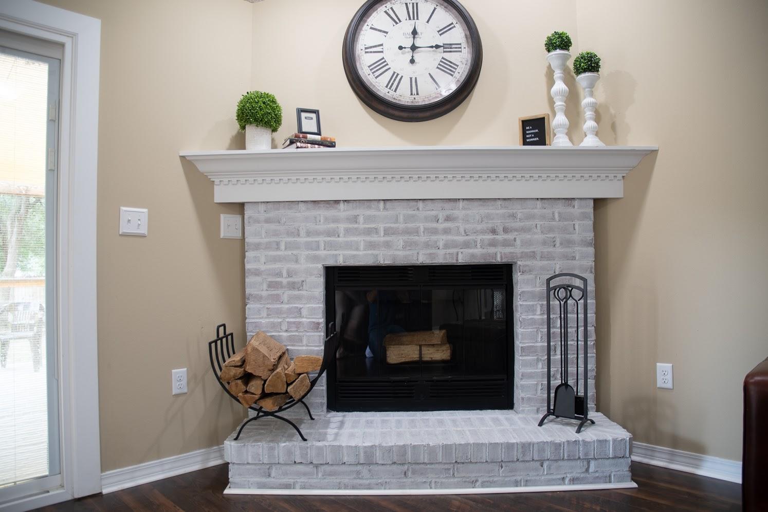 2802 Ping Lane Crestview, FL 32539 - Photo 6 of 30 a living room with a fireplace a clock and a window