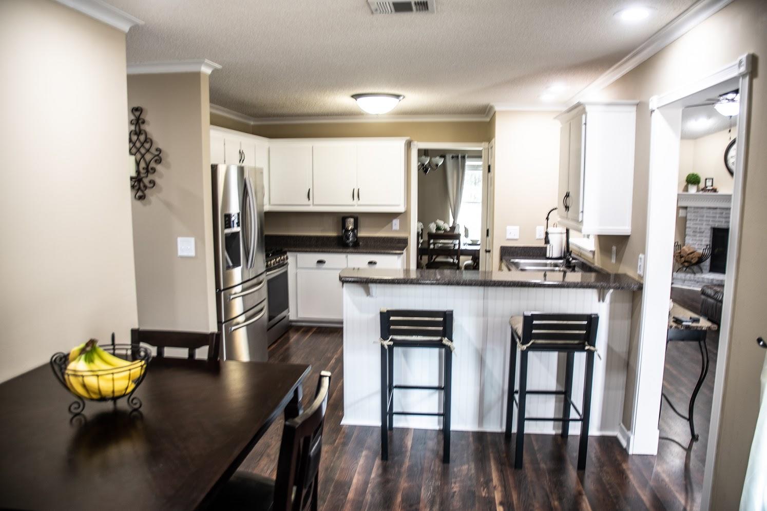 2802 Ping Lane Crestview, FL 32539 - Photo 8 of 30 a kitchen with stainless steel appliances a dining table chairs and granite counter tops