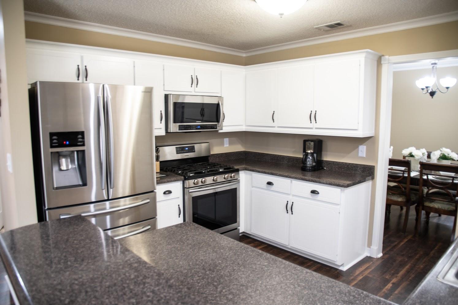2802 Ping Lane Crestview, FL 32539 - Photo 9 of 30 a kitchen with stainless steel appliances granite countertop a refrigerator stove microwave and sink