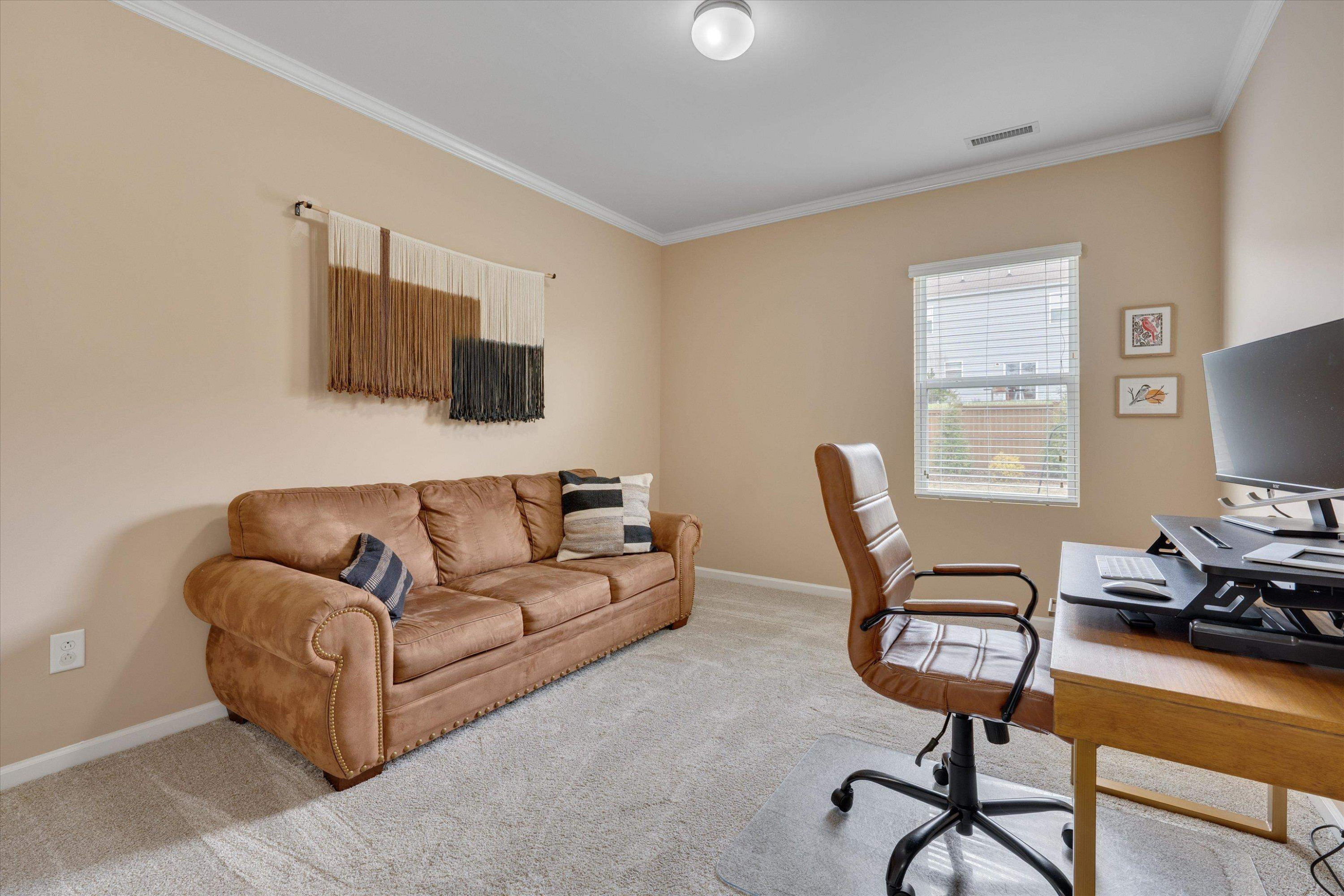 3717 Althorp Drive Raleigh, NC 27616 - Photo 12 of 23 a living room with furniture a flat screen tv and a window