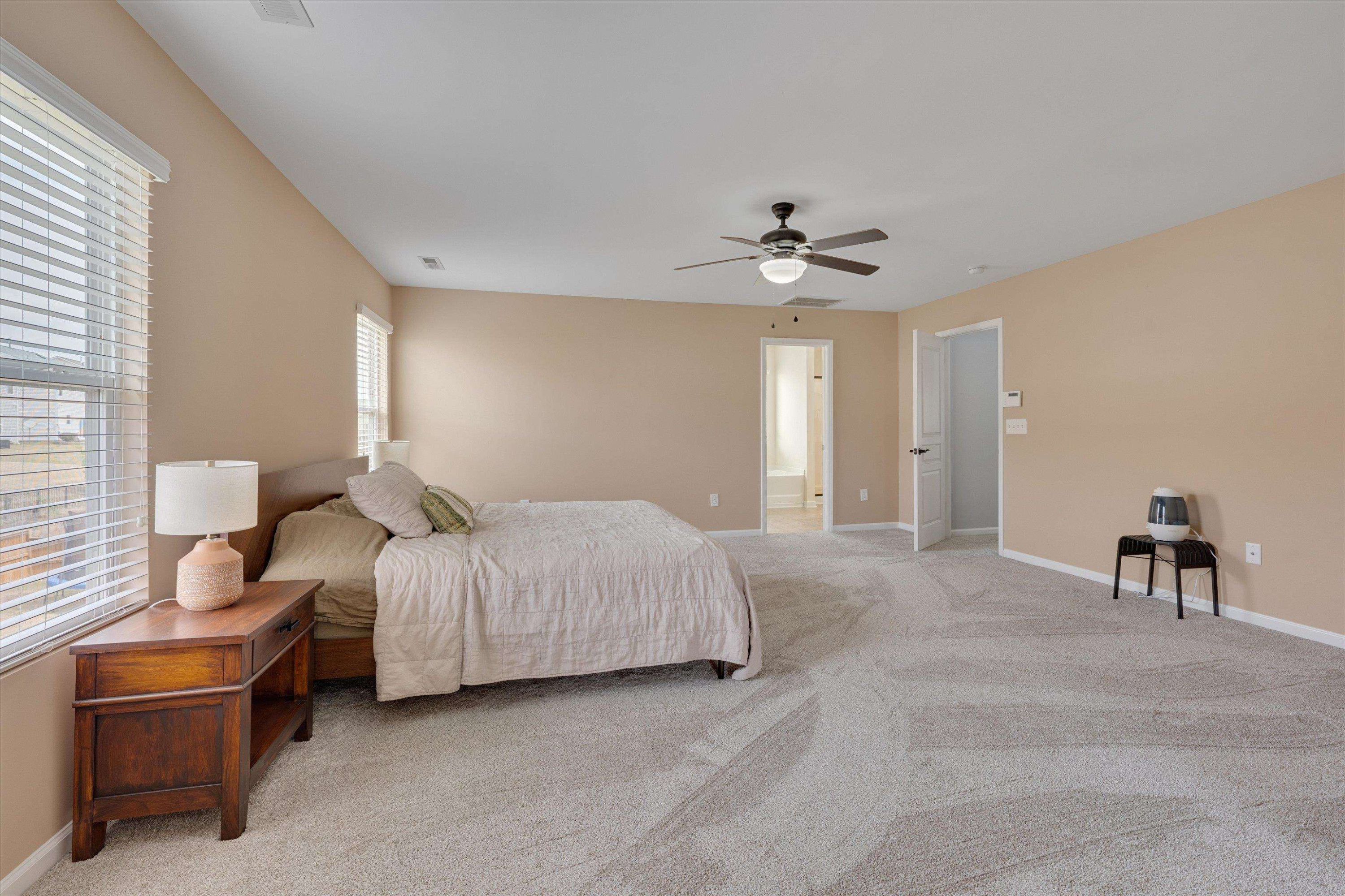 3717 Althorp Drive Raleigh, NC 27616 - Photo 15 of 23 a spacious bedroom with a bed and a chandelier