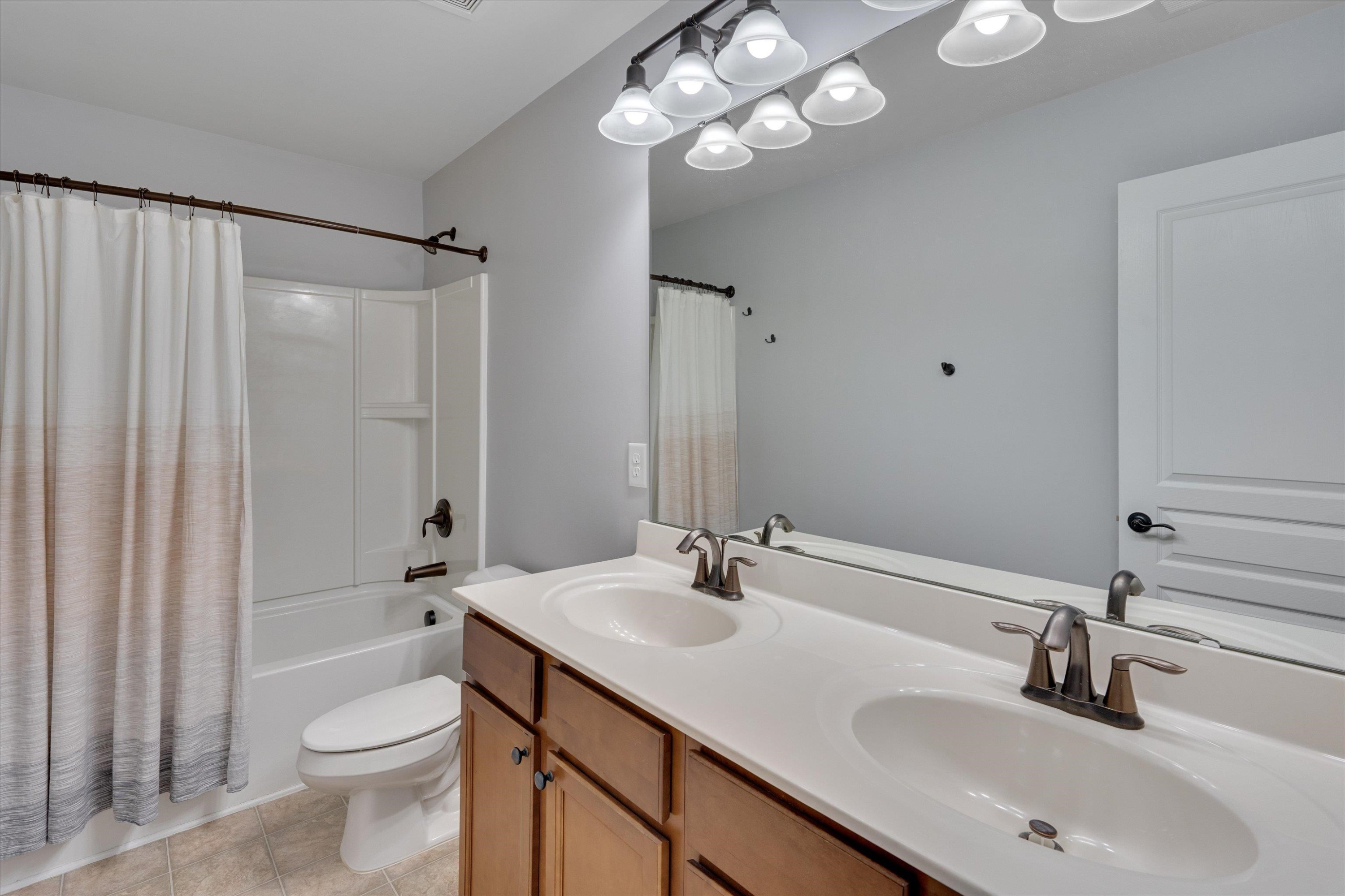 3717 Althorp Drive Raleigh, NC 27616 - Photo 19 of 23 a bathroom with a sink a toilet and shower