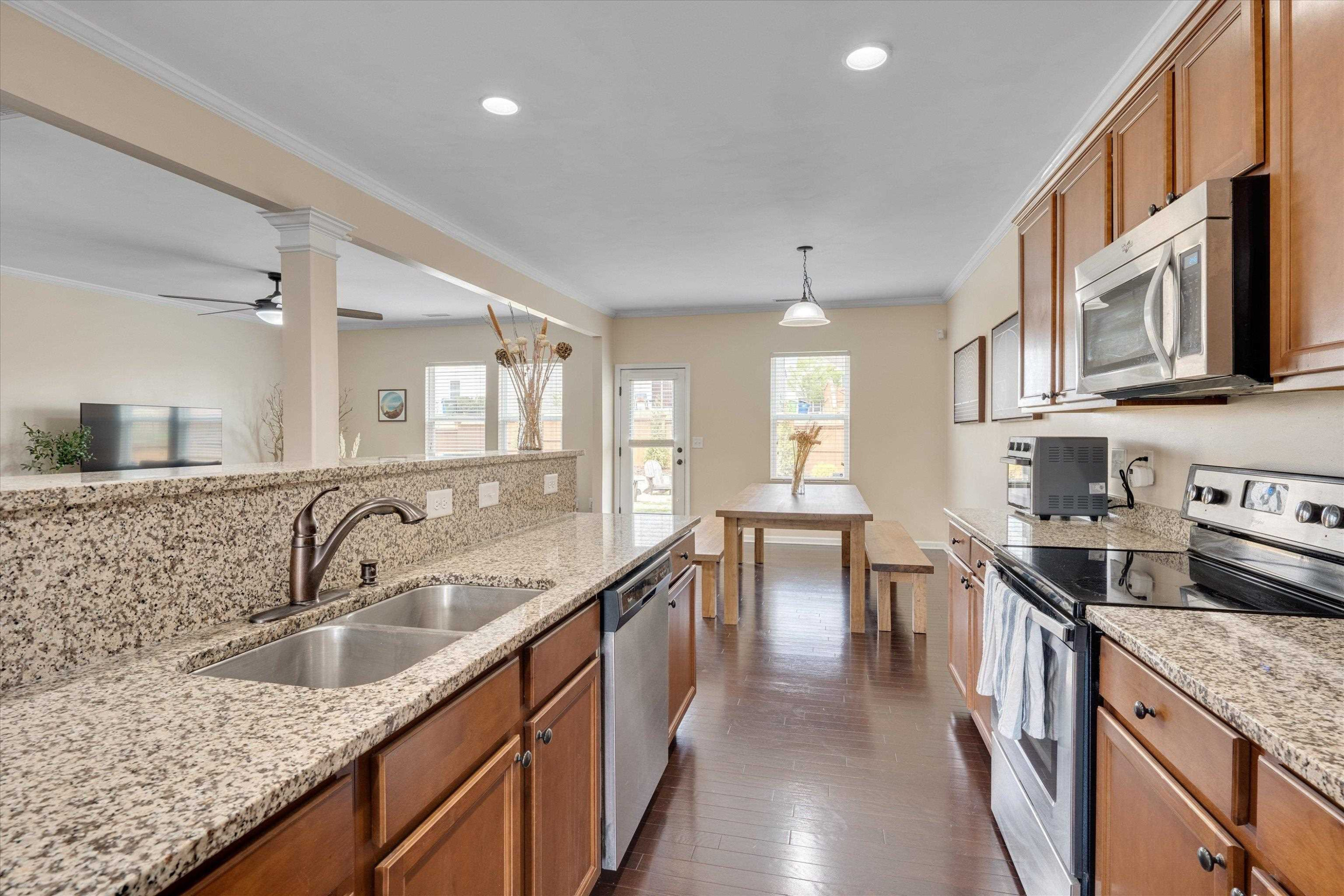 3717 Althorp Drive Raleigh, NC 27616 - Photo 6 of 23 a kitchen with stainless steel appliances granite countertop a sink stove and cabinets