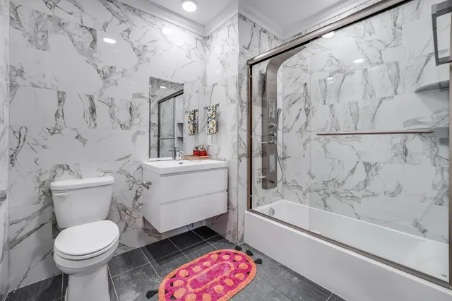 a bathroom with a sink toilet and shower