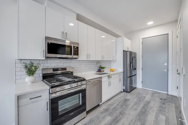 a kitchen with a refrigerator stove and microwave