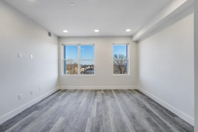 a view of room with window and wooden floor