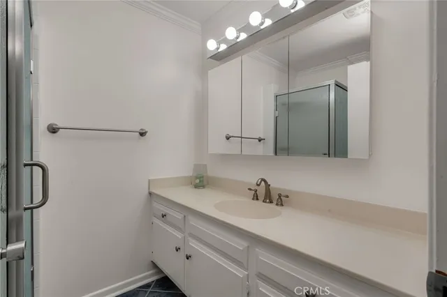 a bathroom with a glass shower door