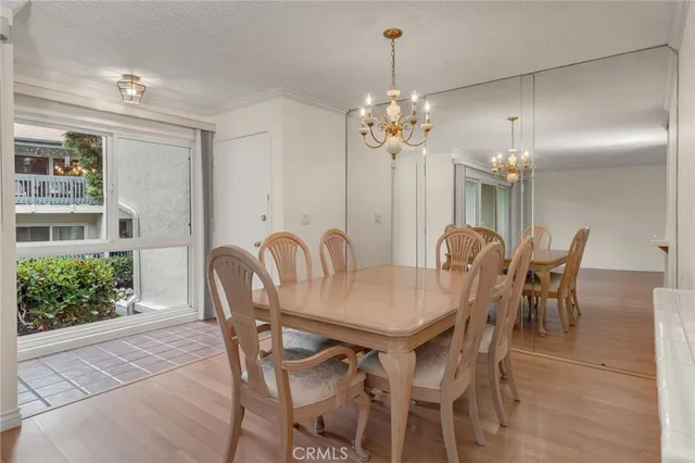 a view of a dining room with furniture and chandelier