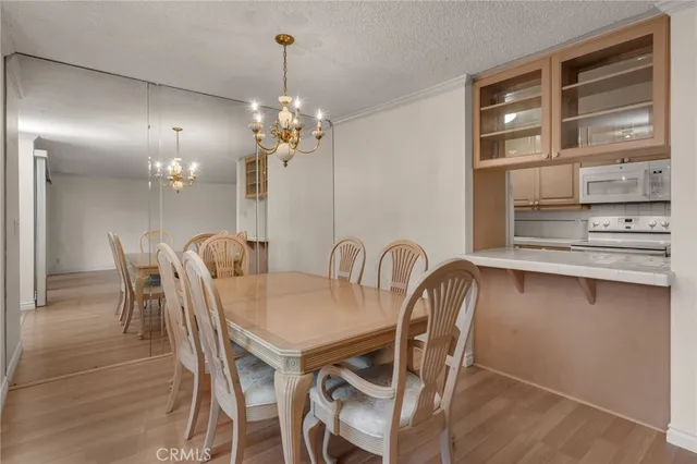 a view of a dining room with furniture and chandelier