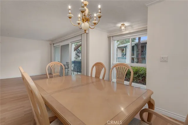 a dining room with furniture and chandelier