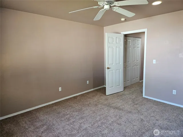 an empty room with fan and fan