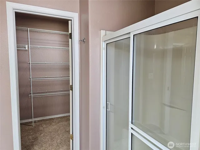 a bathroom with a glass shower door