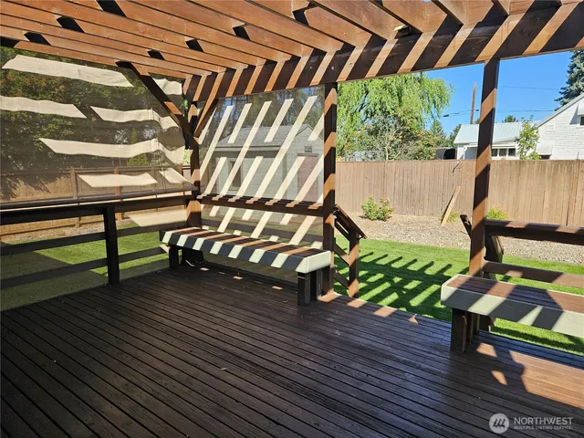 a view of backyard with garden and deck