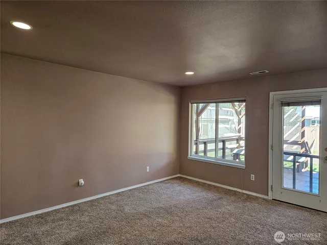 an empty room with windows and closet