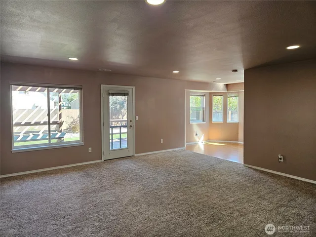 an empty room with windows and closet