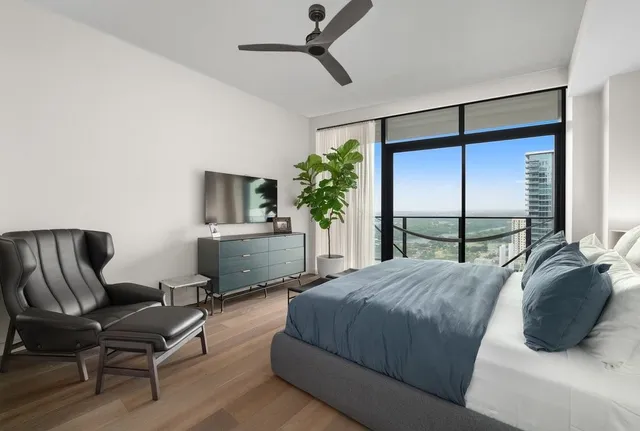 a bedroom with a bed window and potted plant
