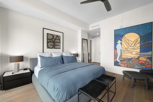 a bedroom with a bed a couch and a window