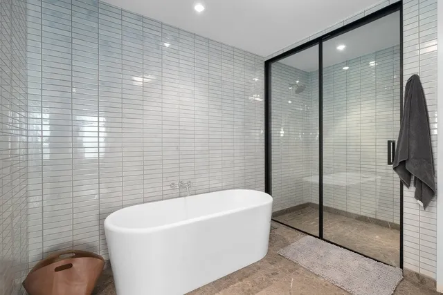 a bathroom with a bathtub and shower