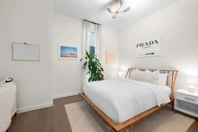 a bedroom with a bed and a potted plant