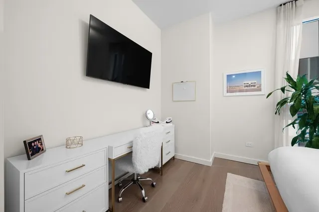 a view of a workspace with furniture and a flat screen tv