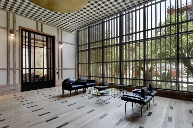 a living room with furniture and a floor to ceiling window