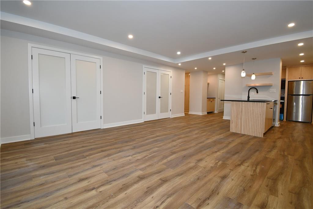 112 Washington Place, Unit 2G Pittsburgh, PA 15219 - Photo 11 of 26 a view of a hallway with wooden floor