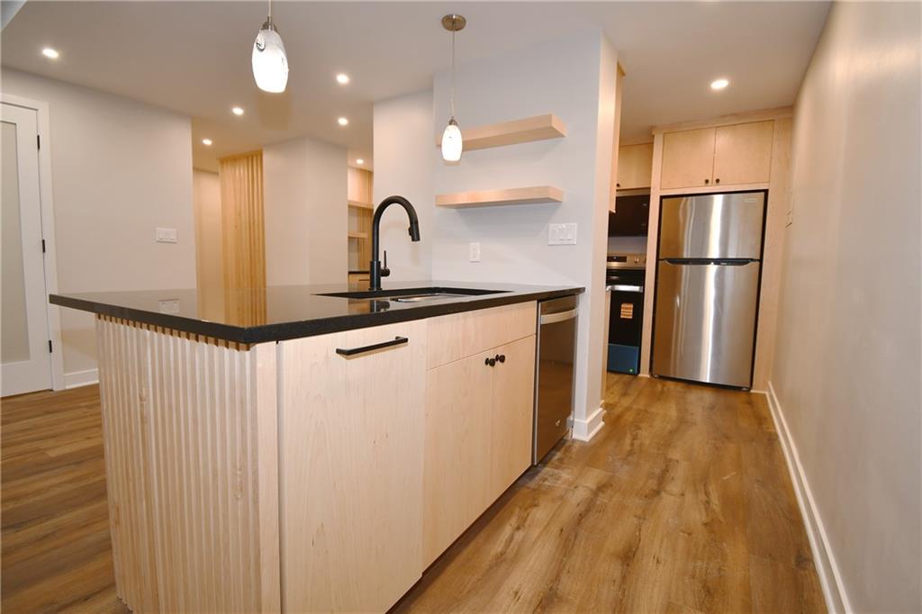 112 Washington Place, Unit 2G Pittsburgh, PA 15219 - Photo 13 of 26 a kitchen with stainless steel appliances a refrigerator and a sink