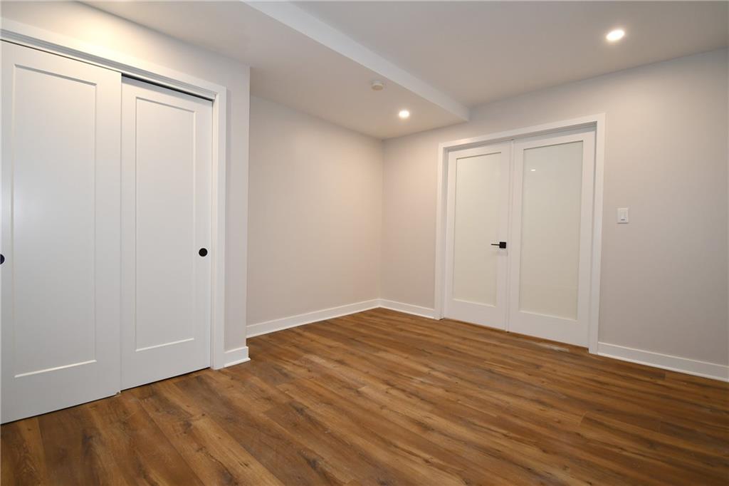 112 Washington Place, Unit 2G Pittsburgh, PA 15219 - Photo 17 of 26 a view of room with wooden floor