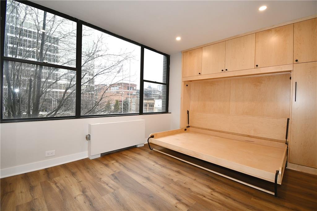 112 Washington Place, Unit 2G Pittsburgh, PA 15219 - Photo 19 of 26 a view of a room with wooden floor and windows