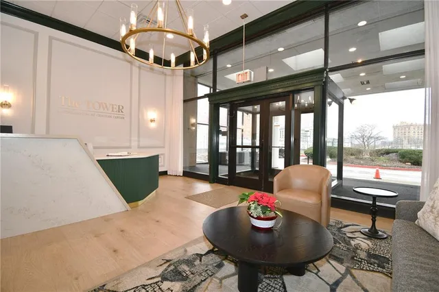 a living room with furniture and a chandelier