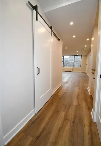 a view of a hallway with wooden floor