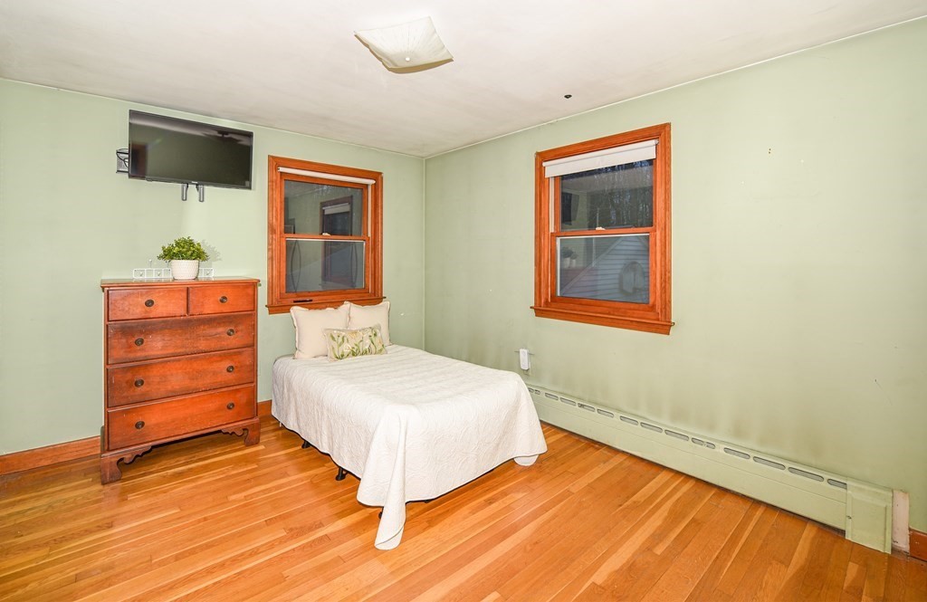 63 Kemp Street Groton, MA 01450 - Photo 11 of 24 a bedroom with a bed and a flat screen tv