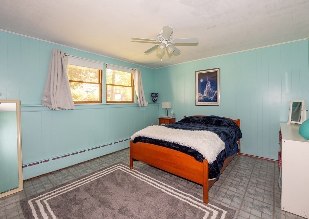 63 Kemp Street Groton, MA 01450 - Photo 13 of 24 a bedroom with a bed and a chandelier