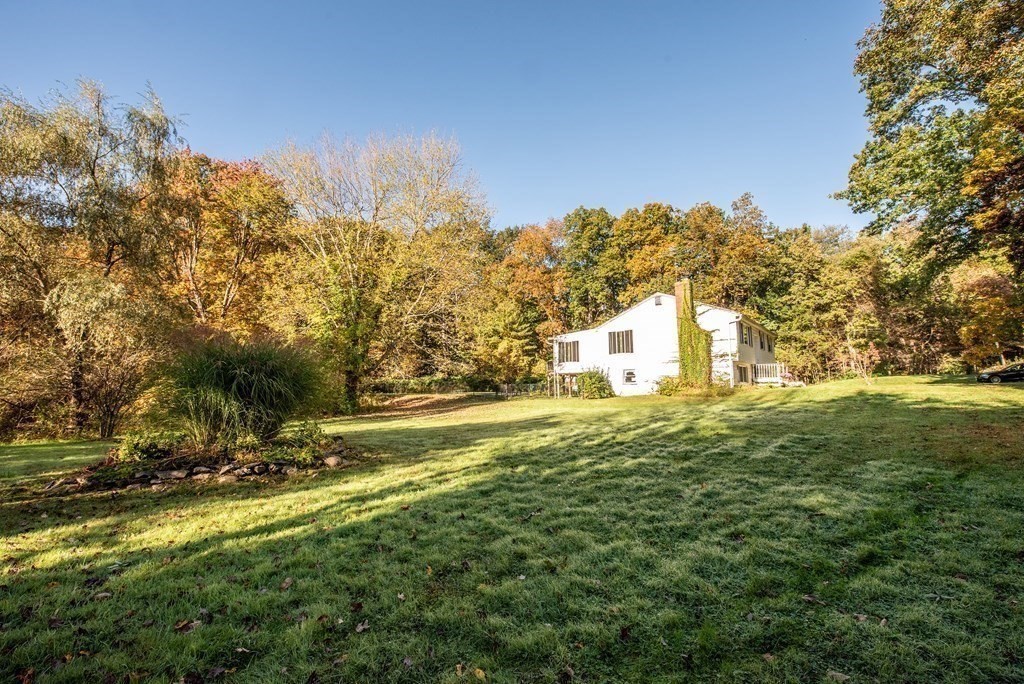 63 Kemp Street Groton, MA 01450 - Photo 23 of 24 a view of a large yard with swimming pool and trees