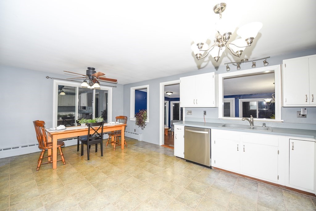 63 Kemp Street Groton, MA 01450 - Photo 3 of 24 a large white kitchen with a table and chairs