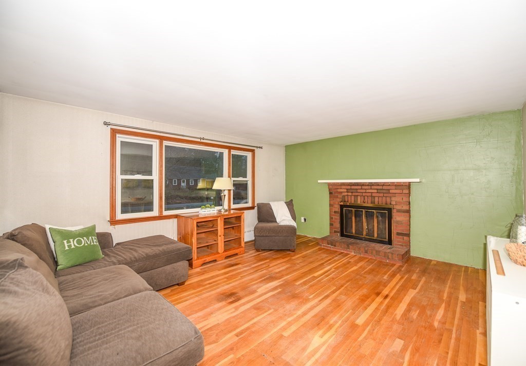 63 Kemp Street Groton, MA 01450 - Photo 4 of 24 a living room with furniture and a fireplace