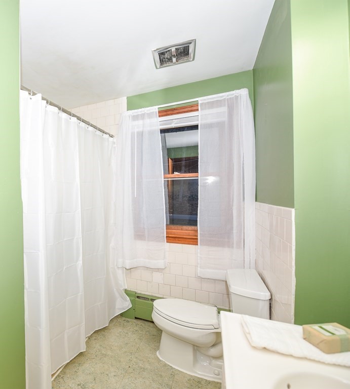 63 Kemp Street Groton, MA 01450 - Photo 10 of 24 a bathroom with a toilet a sink and a mirror