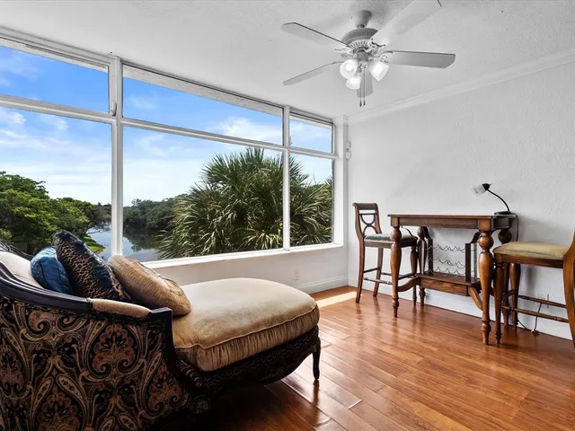a living room with furniture a table and a large window