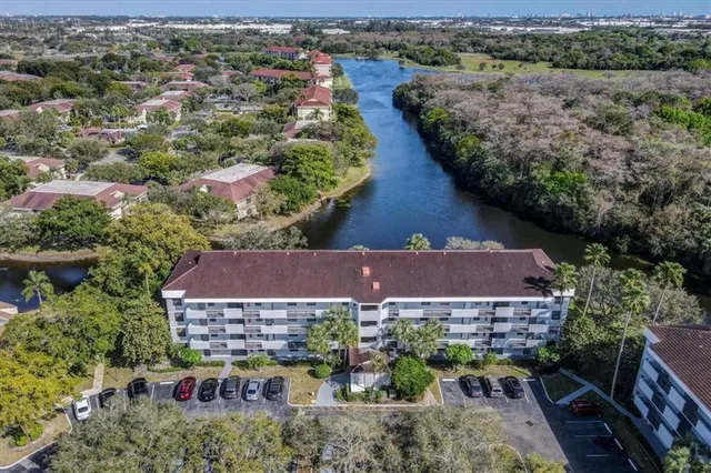 an aerial view of house with yard and ocean view