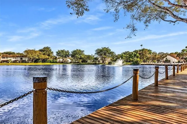 a view of a balcony with wooden floor and a table