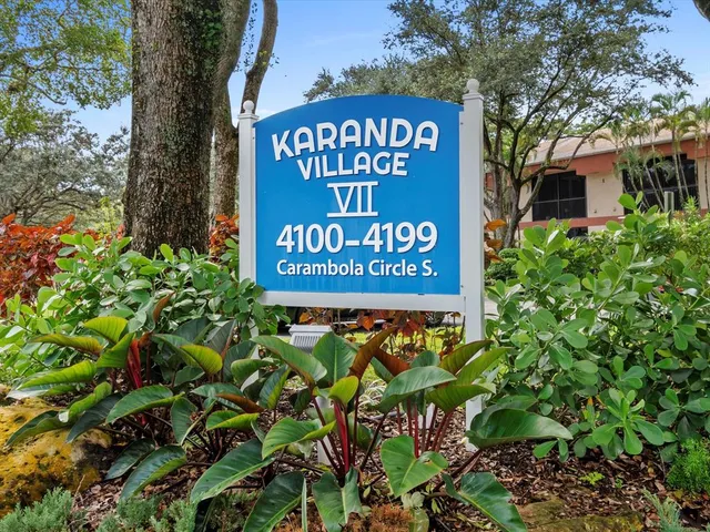 a sign that is sitting in front of flowers