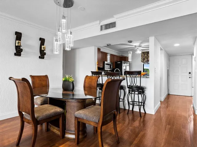 a view of a dining room with furniture and wooden floor