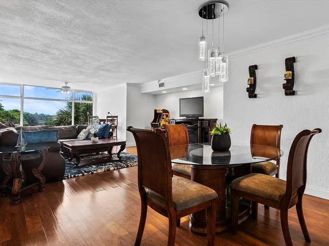 a view of a dining room with furniture and wooden floor