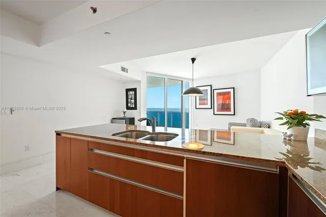 a kitchen with stainless steel appliances a refrigerator and a stove top oven