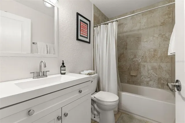 a bathroom with a sink a toilet and a bathtub