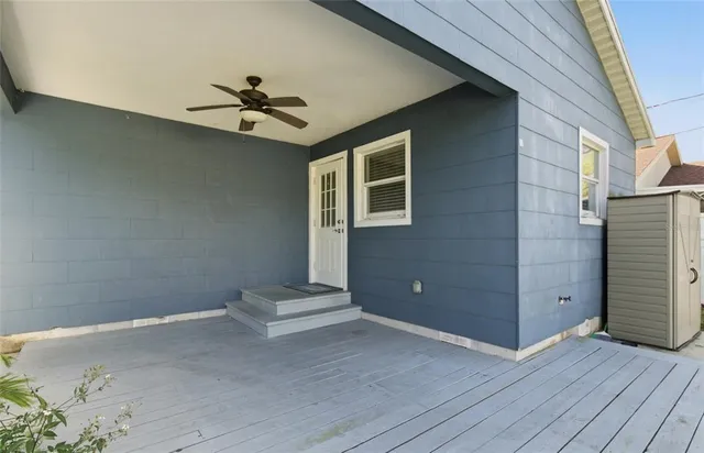 an empty room with wooden floor closet and windows